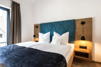 Ein Bett oder Betten in einem Zimmer der Unterkunft Ferienwohnungen Assenmacher mit Sauna