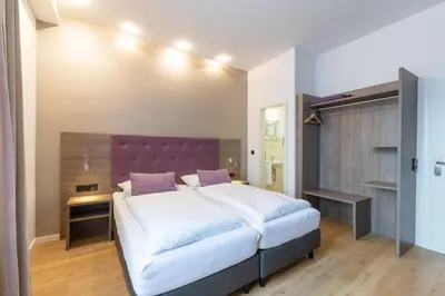 Ein Bett oder Betten in einem Zimmer der Unterkunft Hotel Porta Nigra