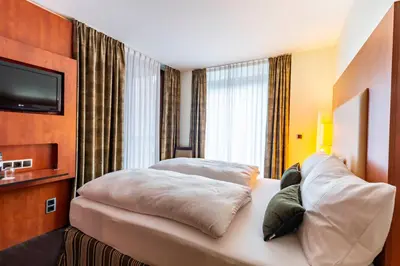 Ein Bett oder Betten in einem Zimmer der Unterkunft DAS WESEL - DEIN HOTEL AM RHEIN