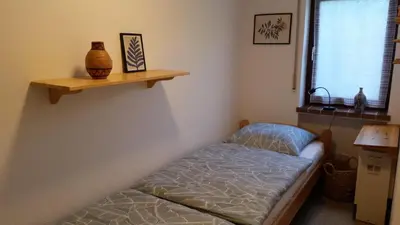 Ein Bett oder Betten in einem Zimmer der Unterkunft Ferienhaus Eifelhöhe mit Maarpanorama