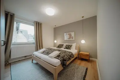 Ein Bett oder Betten in einem Zimmer der Unterkunft Coblenz Suites - Design Apartment City