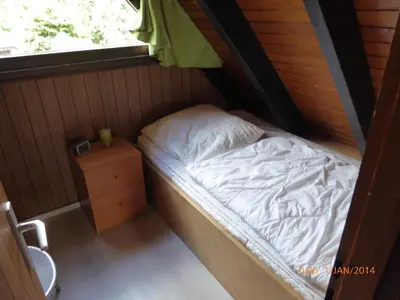 Ein Bett oder Betten in einem Zimmer der Unterkunft Eifelwaldhäuschen