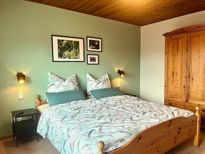 Ein Bett oder Betten in einem Zimmer der Unterkunft Pension 1595 im Weingut Botzet