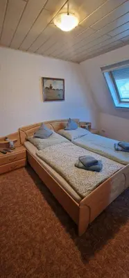 Ein Bett oder Betten in einem Zimmer der Unterkunft Gästehaus Eulenköpfchen