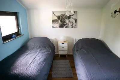 Ein Bett oder Betten in einem Zimmer der Unterkunft Ferienhaus Eifelfreude