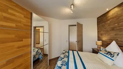 Ein Bett oder Betten in einem Zimmer der Unterkunft Ferienwohnung Exclusiv-Apartment Seepanorama - im Maarberg Resort - in Schalkenmehren am See