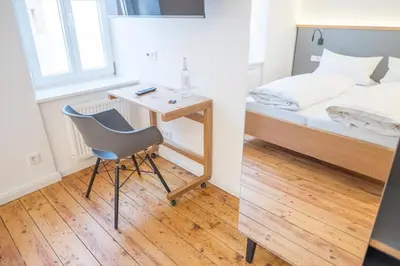 Ein Bett oder Betten in einem Zimmer der Unterkunft BG Living & Hosting - Historisches Ferienhaus 