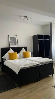 Ein Bett oder Betten in einem Zimmer der Unterkunft City Apartments Trier Suite 8