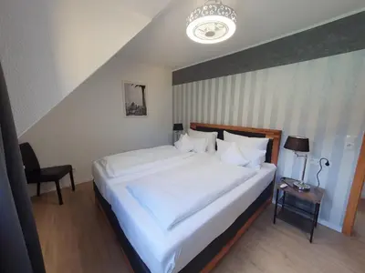 Ein Bett oder Betten in einem Zimmer der Unterkunft Gästehaus Burgberg, Weinhaus Fries
