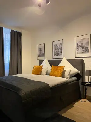Ein Bett oder Betten in einem Zimmer der Unterkunft City Apartments Trier Suite 3