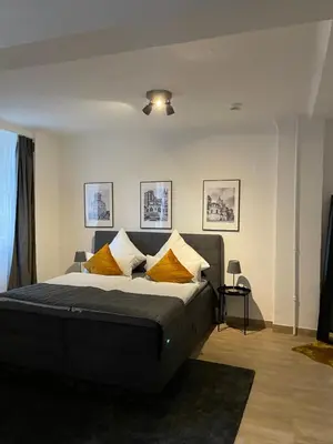 Ein Bett oder Betten in einem Zimmer der Unterkunft City Apartments Trier Suite 3