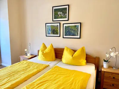 Ein Bett oder Betten in einem Zimmer der Unterkunft Burggarten Wine Residences - Wein direkt vom Winzer, eBike & eAuto aufladen und parken