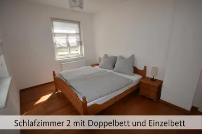 Ein Bett oder Betten in einem Zimmer der Unterkunft Ferienhaus Anno 1912