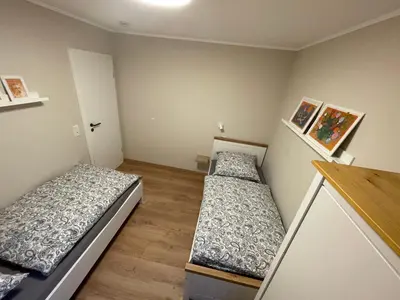 Ein Bett oder Betten in einem Zimmer der Unterkunft Ferienhaus Eifelgruß, in schöner Waldrandlage und tollem Naturgarten