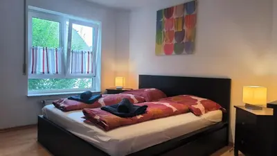 Ein Bett oder Betten in einem Zimmer der Unterkunft Spacious Ferienwohnung nähe KOB Uni