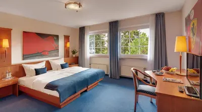 Ein Bett oder Betten in einem Zimmer der Unterkunft Motorsport Hotel