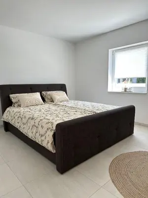 Ein Bett oder Betten in einem Zimmer der Unterkunft Domi Apartment