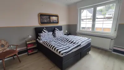 Ein Bett oder Betten in einem Zimmer der Unterkunft Ferienhaus Moselpanorama