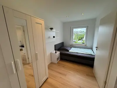 Ein Bett oder Betten in einem Zimmer der Unterkunft Ferienwohnung Sonnenhang nähe WHU
