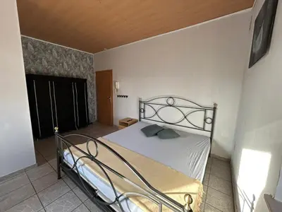 Ein Bett oder Betten in einem Zimmer der Unterkunft Apartment Basile