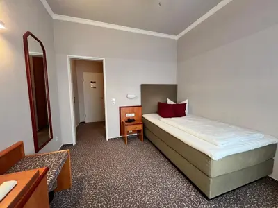 Ein Bett oder Betten in einem Zimmer der Unterkunft Hotel Victoria