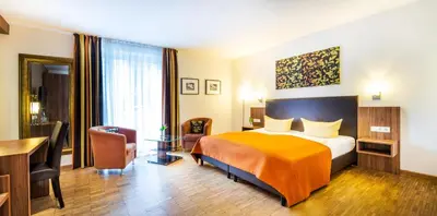 Ein Bett oder Betten in einem Zimmer der Unterkunft Schroeders Stadtwaldhotel