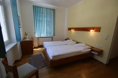 Ein Bett oder Betten in einem Zimmer der Unterkunft Bertricher Hof Hotel Garni