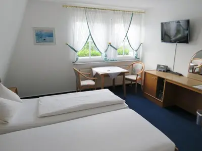 Ein Bett oder Betten in einem Zimmer der Unterkunft Hotel Retterath am Nürburgring