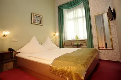 Ein Bett oder Betten in einem Zimmer der Unterkunft Astoria Hotel