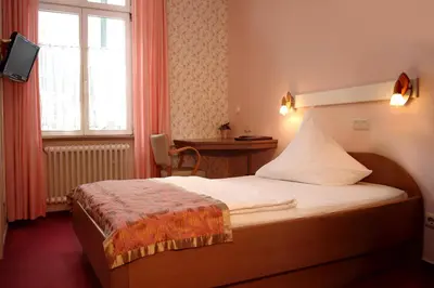 Ein Bett oder Betten in einem Zimmer der Unterkunft Astoria Hotel