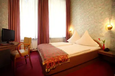 Ein Bett oder Betten in einem Zimmer der Unterkunft Astoria Hotel