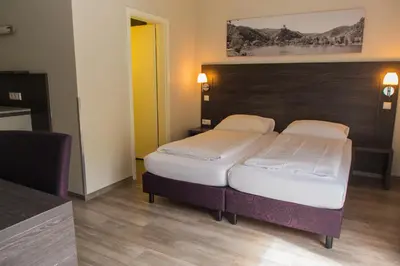 Ein Bett oder Betten in einem Zimmer der Unterkunft aparthotel Cochem