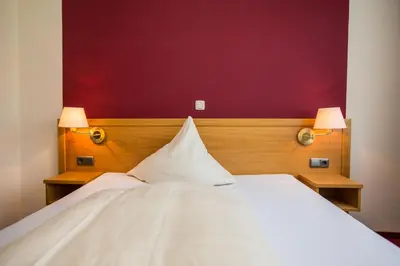Ein Bett oder Betten in einem Zimmer der Unterkunft Hotel Merle