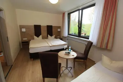 Ein Bett oder Betten in einem Zimmer der Unterkunft Waldhotel Albachmühle