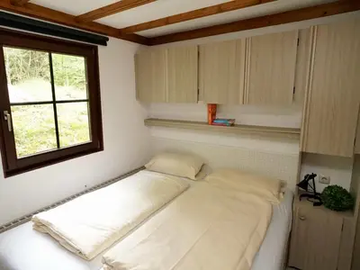 Ein Bett oder Betten in einem Zimmer der Unterkunft Harfenmühle Camping