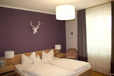 Ein Bett oder Betten in einem Zimmer der Unterkunft Gasthaus Assenmacher