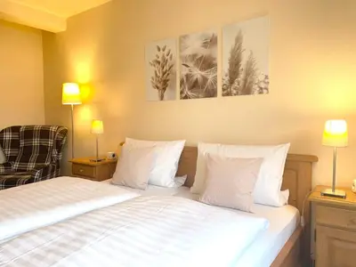 Ein Bett oder Betten in einem Zimmer der Unterkunft Hotel-Pension Hommen