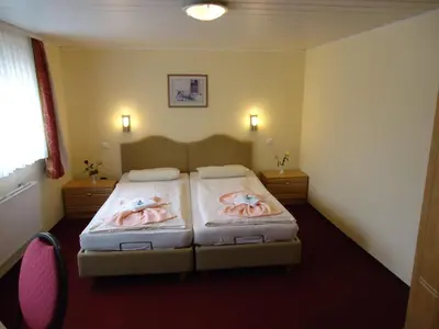 Ein Bett oder Betten in einem Zimmer der Unterkunft Hotel & Restaurant Beckmanns Winzerhaus