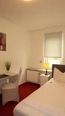 Ein Bett oder Betten in einem Zimmer der Unterkunft Hotel Zur Kripp