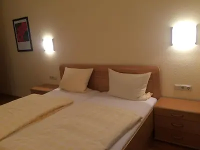 Ein Bett oder Betten in einem Zimmer der Unterkunft Moselhotel Lesura