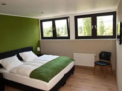 Ein Bett oder Betten in einem Zimmer der Unterkunft Landgasthof Ralinger Hof