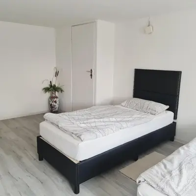 Ein Bett oder Betten in einem Zimmer der Unterkunft Boardinghouse Leiwen 46