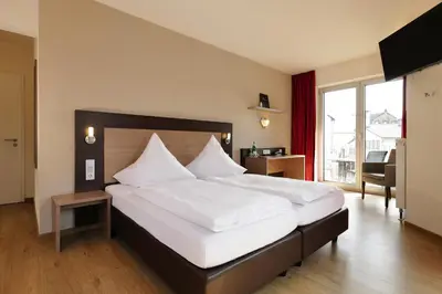 Ein Bett oder Betten in einem Zimmer der Unterkunft Hotel Moseldomizil