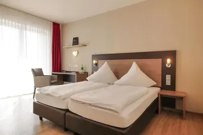Ein Bett oder Betten in einem Zimmer der Unterkunft Hotel Moseldomizil