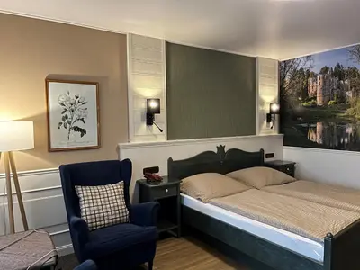 Ein Bett oder Betten in einem Zimmer der Unterkunft Pension Zum Golfstübchen