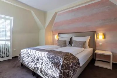 Ein Bett oder Betten in einem Zimmer der Unterkunft Jagdschloss Hotel Niederwald