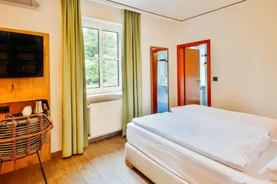 Ein Bett oder Betten in einem Zimmer der Unterkunft Landhotel Kauzenberg