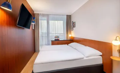 Ein Bett oder Betten in einem Zimmer der Unterkunft Wyndham Garden Lahnstein Koblenz