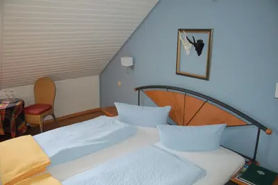 Ein Bett oder Betten in einem Zimmer der Unterkunft Hotel Leander
