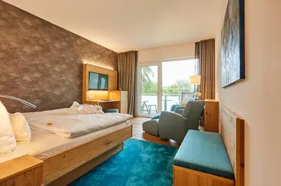 Ein Bett oder Betten in einem Zimmer der Unterkunft Hotel Villa Hügel